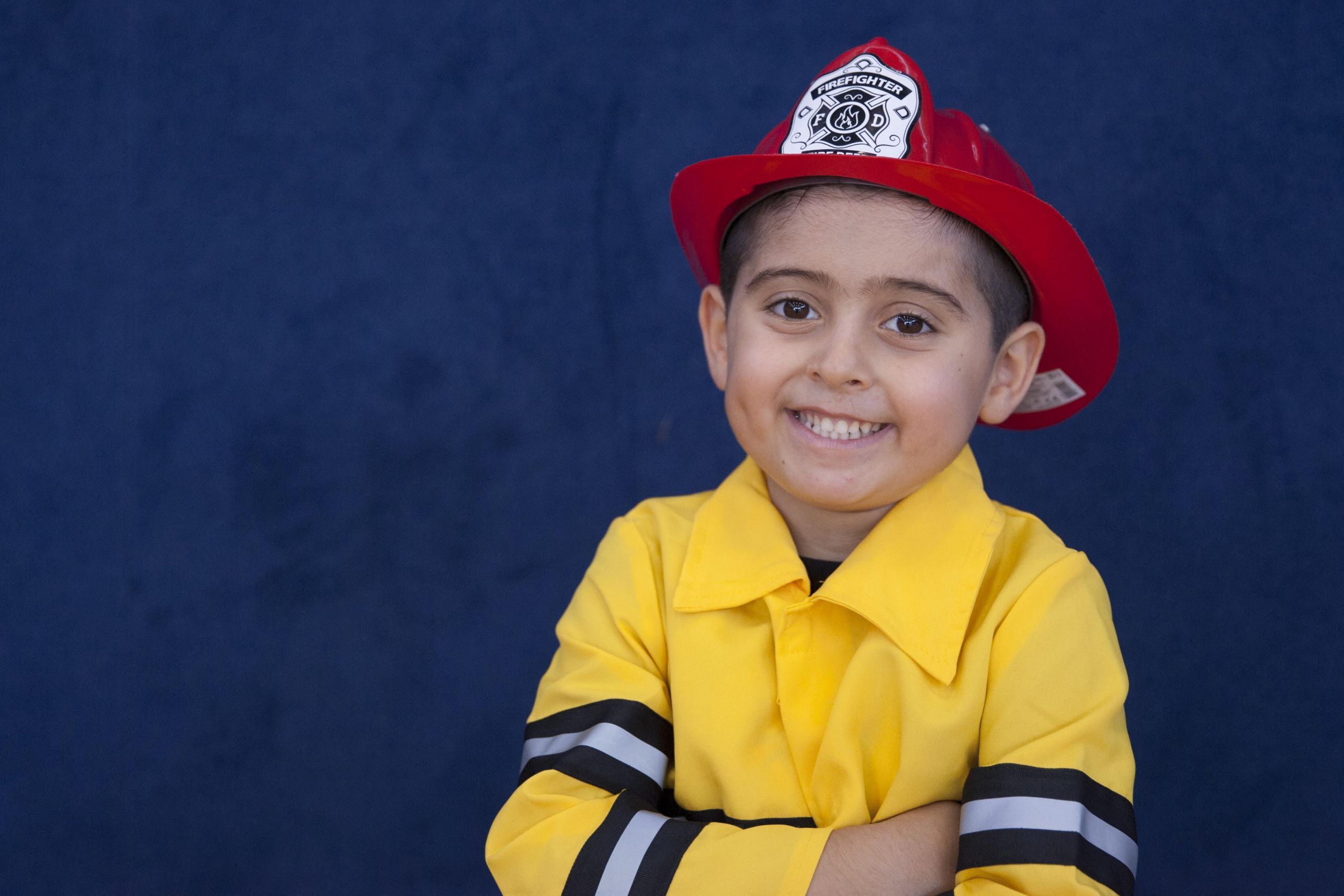 Boy with red fire helmet