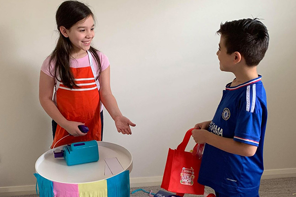 A Year 4 Holy Spirit Catholic Primary School Carnes Hill student serves a customer at her shopfront