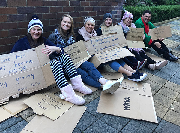 St Patrick’s Catholic Primary School Sutherland staff hold up signs highlighting the plight of the homeless in Australia