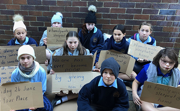 FamilyWinterSleepout@Home St Patrick’s Catholic Primary School Sutherland students with placards highlighting the importance of helping people who are experiencing or at risk of homeless