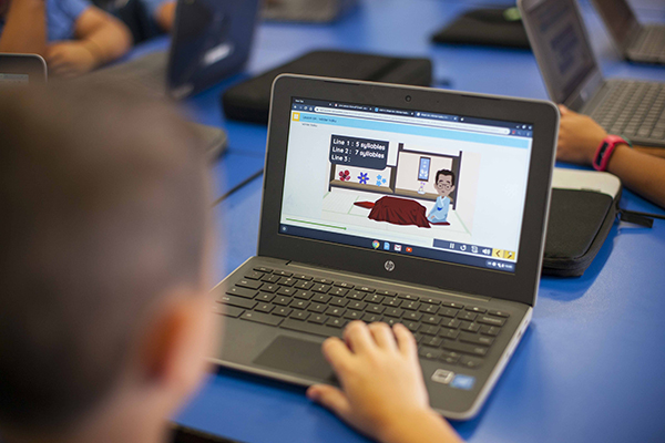 Help keep your child safe online A primary school student learning online on his laptop