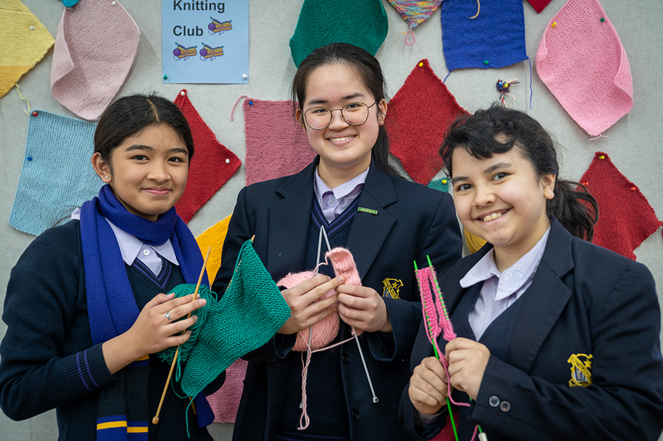 Care squares for charity Bethlehem College Ashfield students Chloe Dionisio, Chloe Juwono and Zanthia Trava knitting together