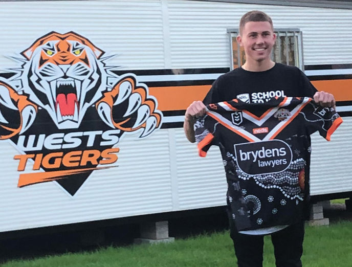 ‘Art runs in my blood’ Marcellin College Randwick student Bill Reynolds with an NRL jersey he designed