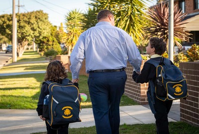 Road Safety Sydney Cathlic Schools parent walking with his children