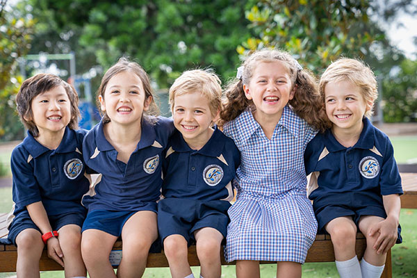 working-with-children students sitting on bench at school