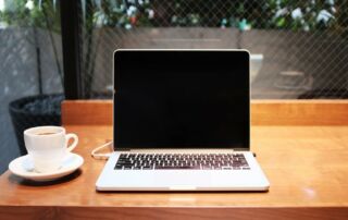 Laptop and cup of coffee on a study desk