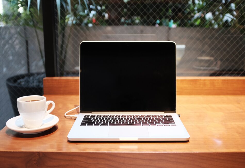 Laptop and cup of coffee on a study desk