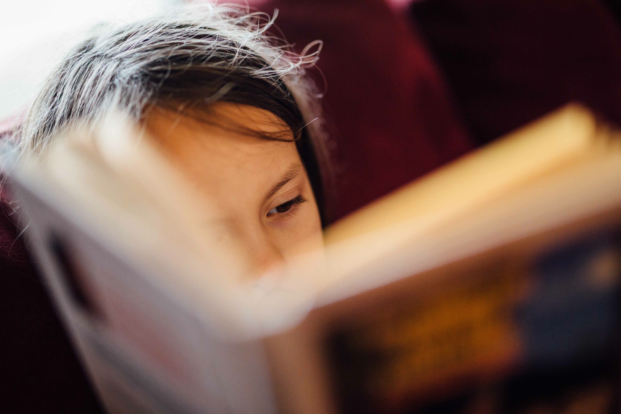 Photo of child reading. Johnny Mcclung- unsplash