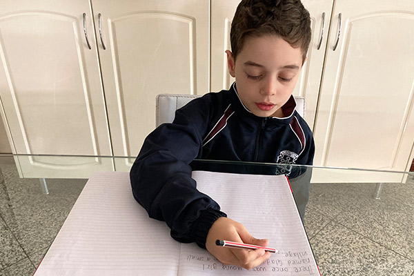 St Michael's Belfield student Leonardo Smith writing