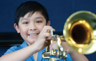 Amadeus Music Education Program student playing an instrument