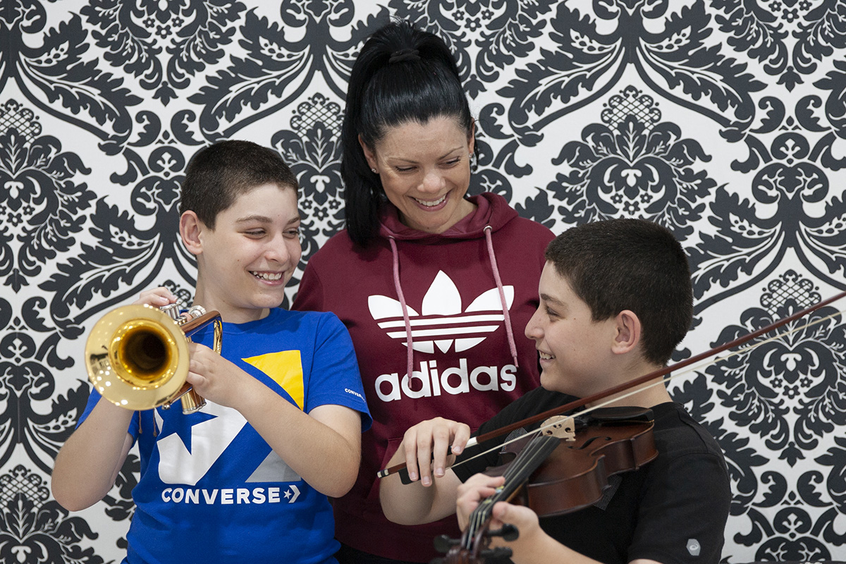 Twins Samuel (trumpet) and Joseph abou Arrage (viola), pictured with mum Nidal, receive music tuition through Sydney Catholic Schools’ Amadeus Music Education Program. Twins Samuel (trumpet) and Joseph abou Arrage (viola), pictured with mum Nidal, receive music tuition through Sydney Catholic Schools' Amadeus Music Education Program.