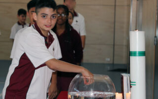 Student with holy water at mass.