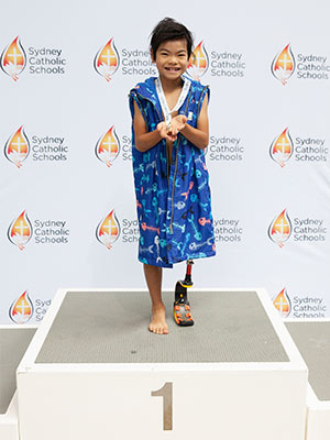 Hudson Wan on the podium receiving his medal