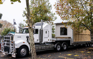 Demountable classrooms are transported from St Patrick's College Sutherland to flood-affected Trinity Catholic College Lismore.