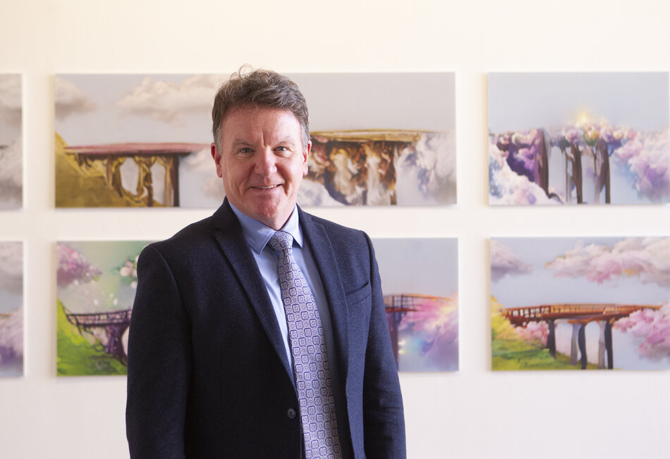 Clancy Prize 2022 Sydney Catholic Schools' Executive Director, Tony Farley, stands in front of a winning Clancy Prize 2022 artwork