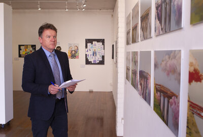 Sydney Catholic Schools' Executive Director, Tony Farley, goes over the choices while judging the 2022 Clancy Religious Art Prize 