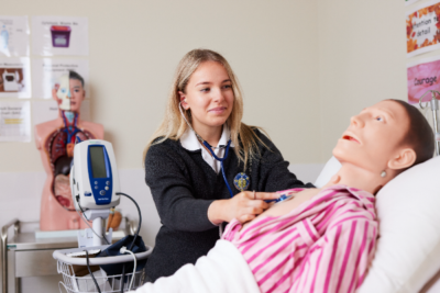 Southern Cross Burwood Health Services Assistance student Macey Danger treats Frank the dummy