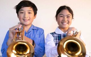 Students play the trumpet as part of the Amadeus Music Education Program at Sydney Catholic Schools.