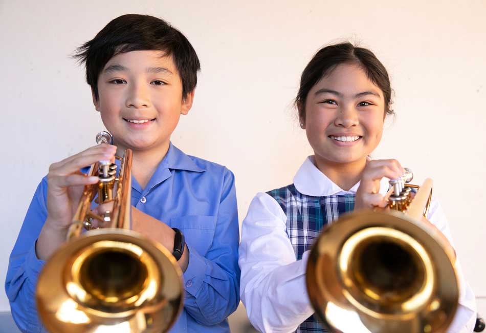 Students play the trumpet as part of the Amadeus Music Education Program at Sydney Catholic Schools.