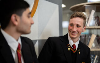 Mental Mates creator Archie Kingham talks with a peer at Marist College Eastwood.