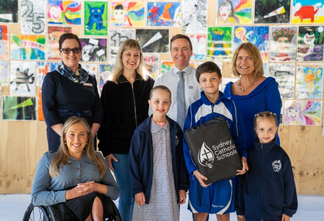 A photo of Volodymyr, his family, Regina Coeli Catholic Primary School Principal, as well as CEF and SCS team members