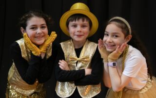 Photo of three Performing Arts students in costume