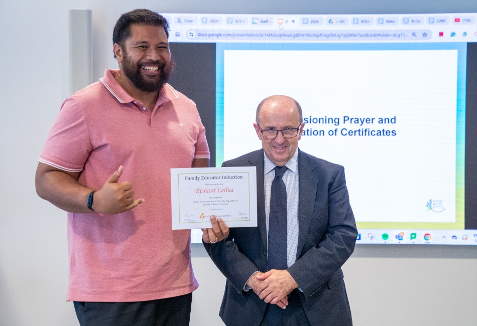 Family educator Richie Leilua receives a certificate from Sydney Catholic Schools' Director: Mission and Identity Anthony Cleary.