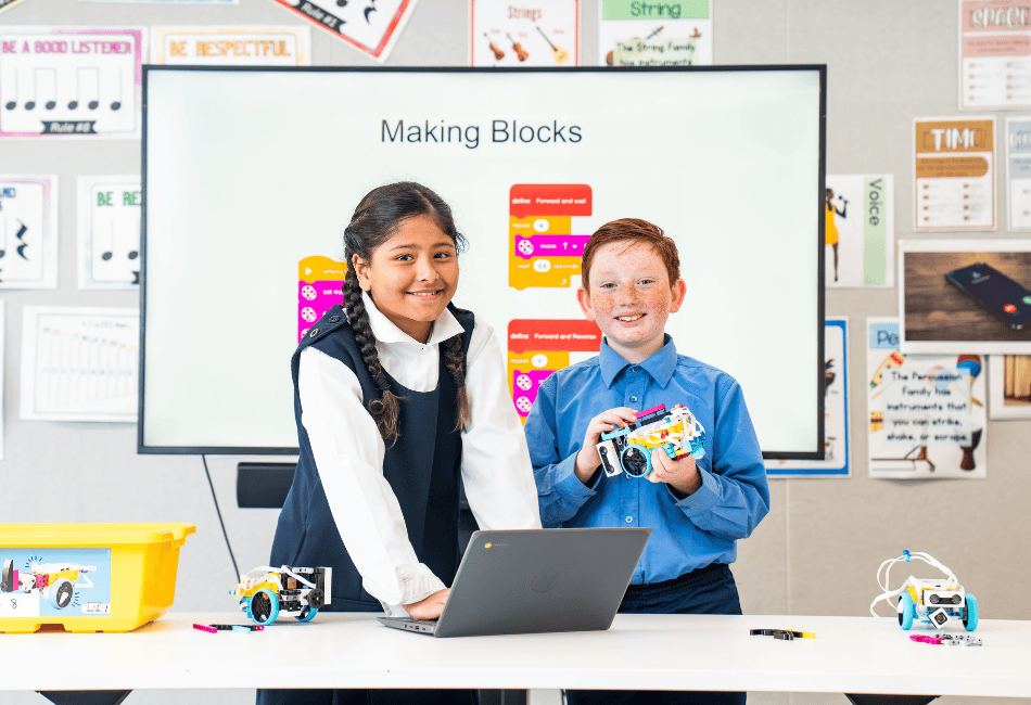 A photo showing two students in a modern classroom learning about the wonders of STEM A photo showing two students in a modern classroom learning about the wonders of STEM