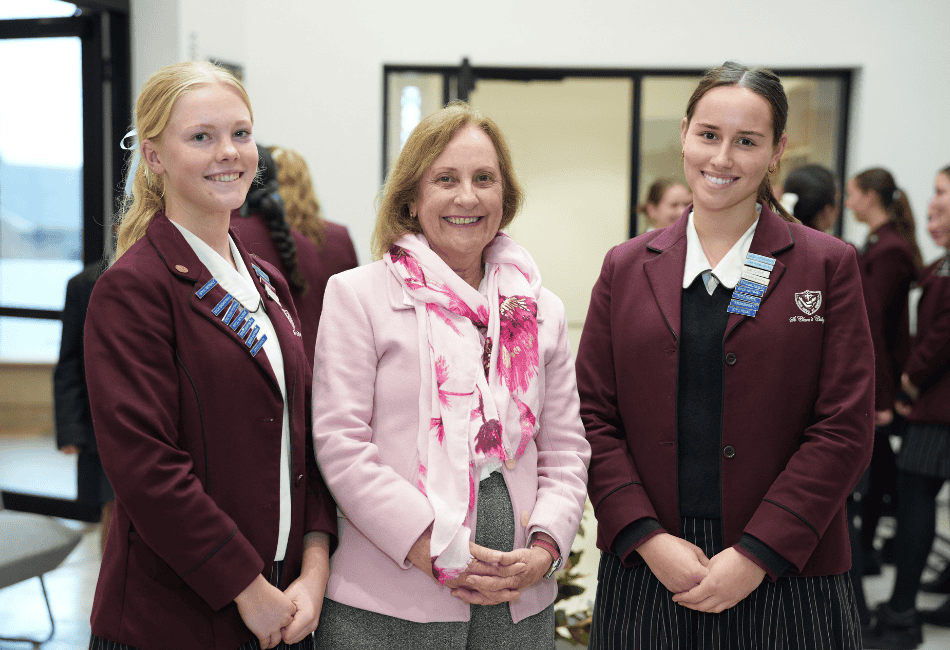 A photo of two students with St Clare's College Waverly Principal Ann Freeman standing in the foyer of the innovative Lumos Centre