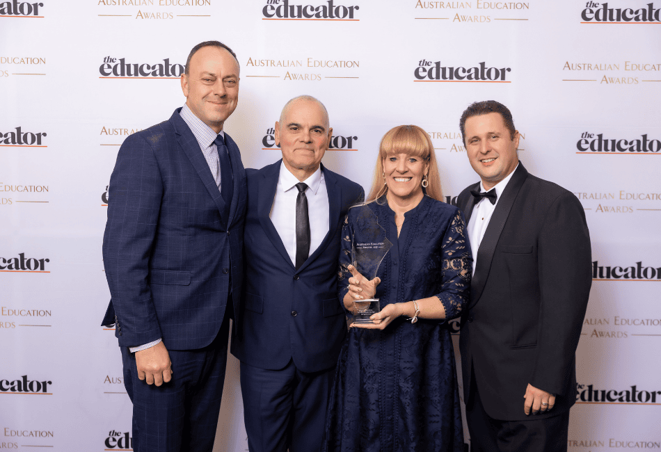 A photo of the Southern Cross Catholic College in Burwood with their award A photo of the Southern Cross Catholic College in Burwood with their award