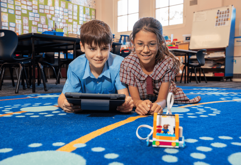 Two Sydney Catholic Schools students exploring STEM through coding and robotics. A photo showing two Sydney Catholic Schools students exploring STEM through coding and robotics.