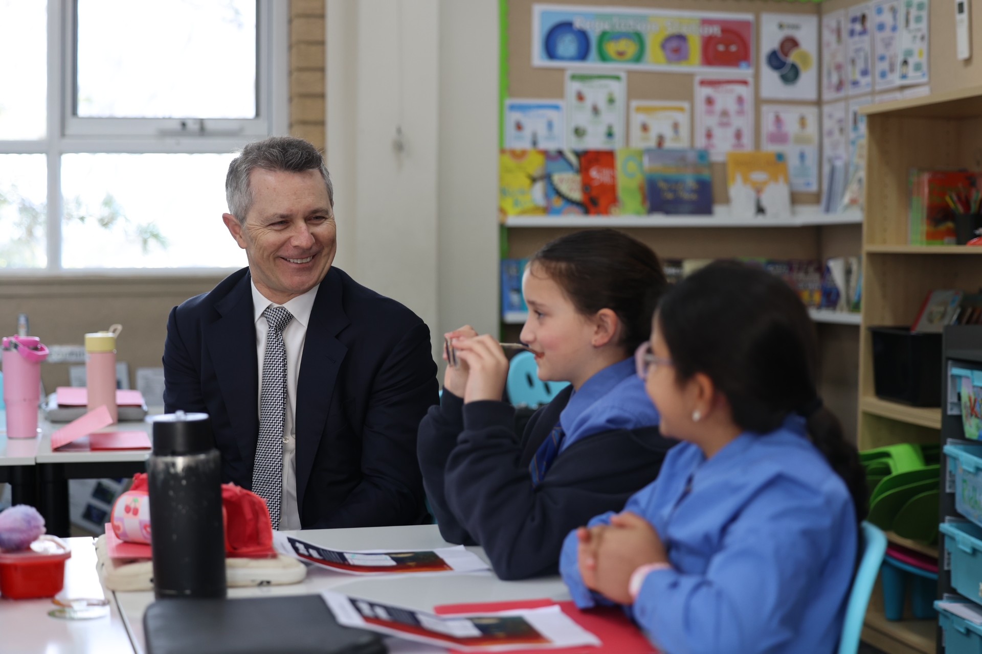 A photo showing Minister for Education Jason Clare interacting with happy students St Luke’s Catholic Primary School Revesby