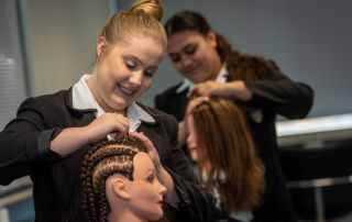 Hairdressing students practicing their skills at Southern Cross Catholic Vocational College Burwood before COVID-19