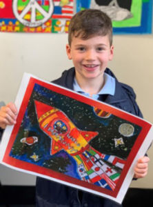 Year 2 student at St Francis de Sales' Catholic Primary School Woolooware, Luca Azetri, with his winning poster entry.