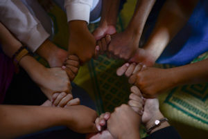 People holding hands in a circle formation