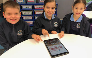 St Michael's Catholic Primary School Meadowbank Year 2 pupils Rafe, Gemma and Elena with the school's 2020 cookbook