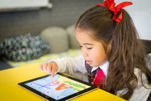 A primary school student uses a device to learn
