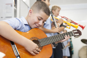 Primary school students practice their musical instruments