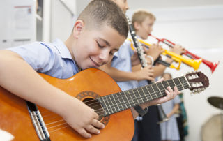 Primary school students practice their musical instruments