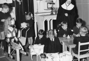 Sister Aidan Hayes teaches St James' kindy students in 1956