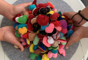 Students of Marion Catholic Primary School Horsley Park hold felt hearts made for staff at Fairfield Hospital