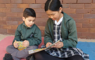 Our Lady of Fatima Primary School Kingsgrove students read a book together