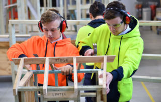 Southern Cross Catholic College Burwood students using hammers on a wooden structure