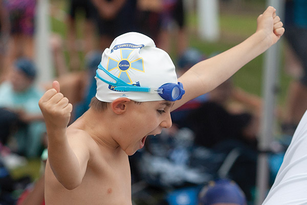 A swimmer cheering at the Sydney Catholic Schools' Zone 5 Swimming Carnival