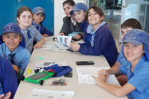 Smiling Sydney Catholic Schools students build solar cars together
