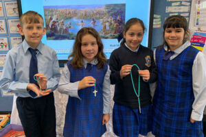 St Charles Waverley Students holding Rosary beads