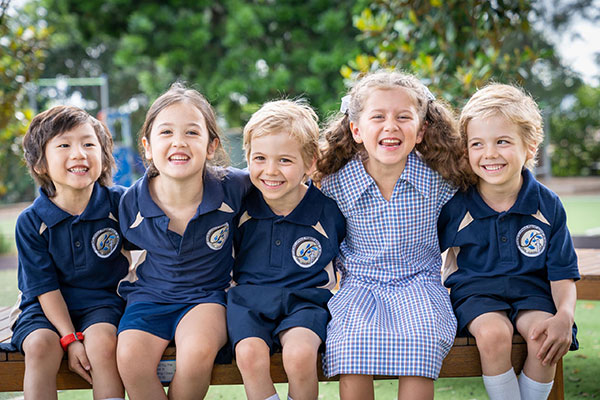 students sitting on bench at school