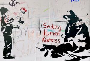 Boy hands flower to man holding sign reading 'Seeking Human Kindness' - Photo by Bekky Bekks on Unsplash