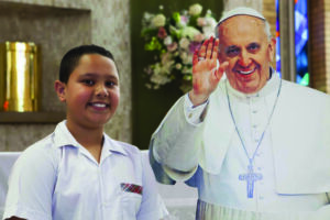 Sydney Catholic Schools' Pope Francis Award recipient with life-size Pope Francis poster