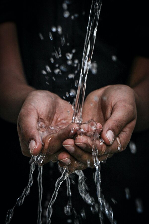 Hands catching water